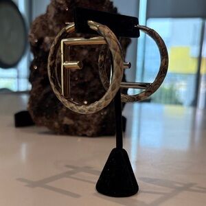 Iconic FENDI snakeskin hoop two tone earrings.